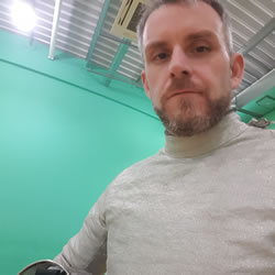 Me wearing a metallic silver jacket, called a Lame, which is used in competitions.